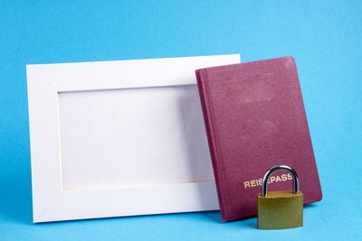 High angle view of open book on table against blue background