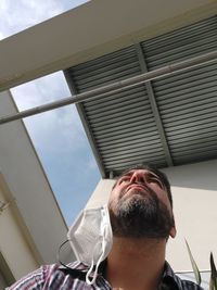 Low angle view of man on window