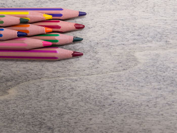 High angle view of colored pencils on wooden table