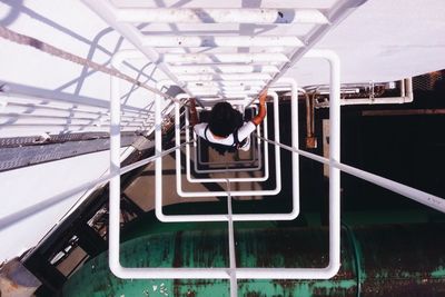 High angle view of young woman standing on built structure