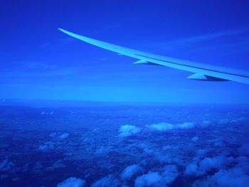 Airplane wing against blue sky