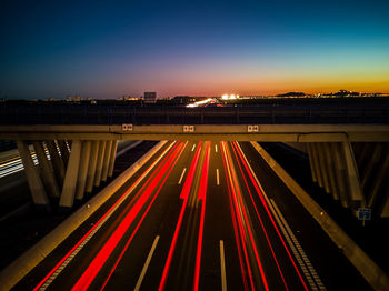 High angle view of light trails on road against sky at night