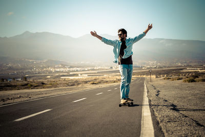 Rear view of man standing on road