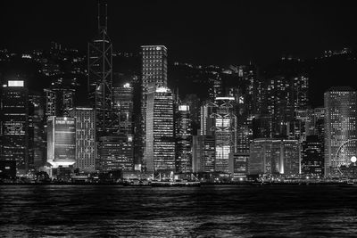 Illuminated buildings against sky at night