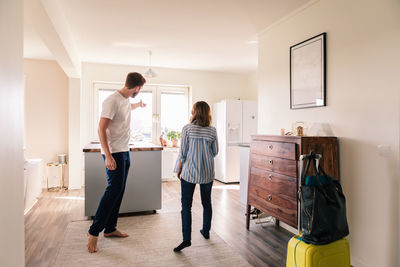 Landlord showing apartment to woman during summer