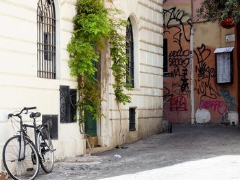 Bicycle outside building by street in city