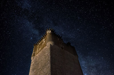 Low angle view of castle against sky at night