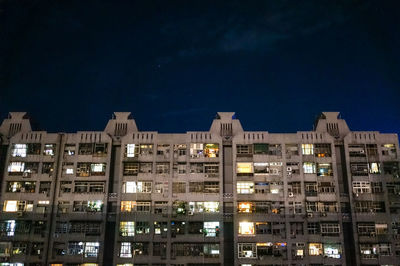 Low angle view of modern buildings against sky at night