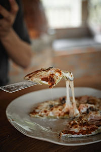 Cropped hand of person having food