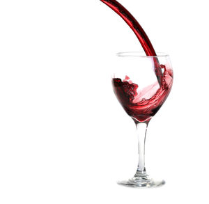 Close-up of red wine against white background