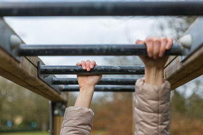 Midsection of man holding while standing on railing