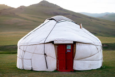 Tent on field against mountain