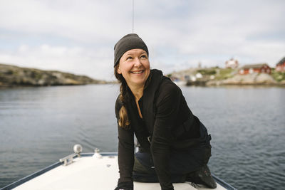 Smiling woman sitting on boat
