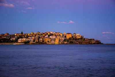 Scenic view of sea and buildings against sky