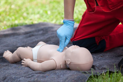 Volunteer giving first aid training with mannequin