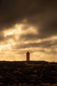 Low angle view of lighthouse against sky during sunset