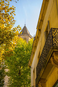 Low angle view of yellow building against sky