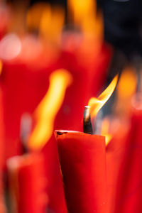 Close-up of lit candles in temple