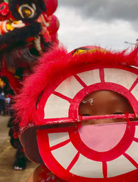 Close-up of red umbrella against sky