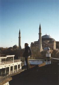 Full length of a man standing in front of historical building