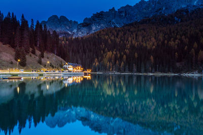Scenic view of lake by snowcapped mountains against sky