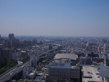 Aerial view of cityscape against clear sky