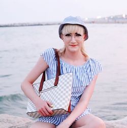 Mid adult woman sitting at beach