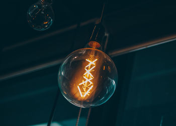 Low angle view of illuminated light bulb