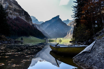 Scenic view of river and mountains against sky