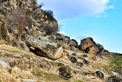 View of rocks on mountain against sky