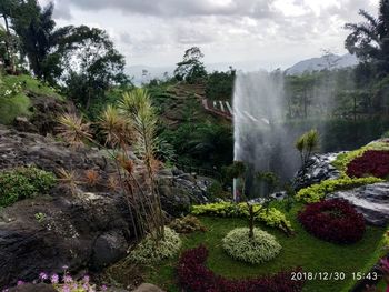 Scenic view of waterfall against sky