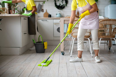 Low section of man standing on floor at home