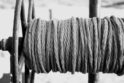 Close-up of rope tied to wooden post