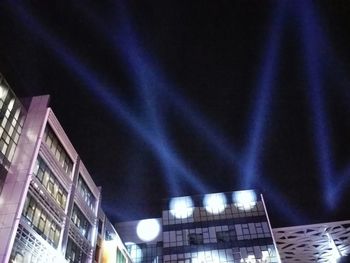 Low angle view of buildings against sky at night