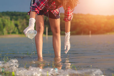 Full length of woman standing in water