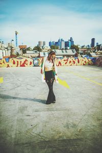 Full length of man with cityscape against clear sky