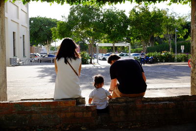Rear view of father and daughter in park