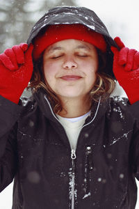 Portrait of smiling woman in snow