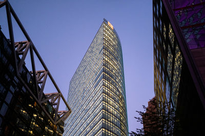 Low angle view of modern buildings against clear blue sky