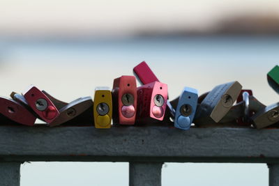 Colorful padlocks on railing