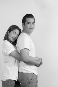 Portrait of friends standing against white background