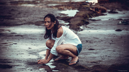 Portrait of smiling young woman on beach