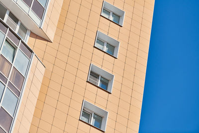 Low angle view of building against clear blue sky