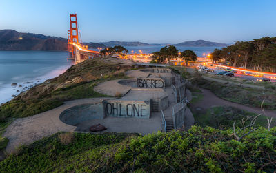 Panoramic view of illuminated bridge against sky at dusk