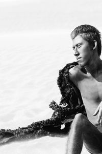 Young man in costume at desert against sky