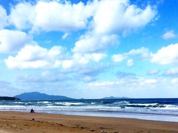 View of beach against cloudy sky