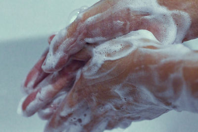 Close-up of hands on wet wall