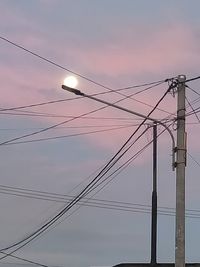 Low angle view of electricity pylon against sky