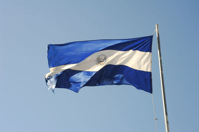 Low angle view of nicaragua flag against clear blue sky