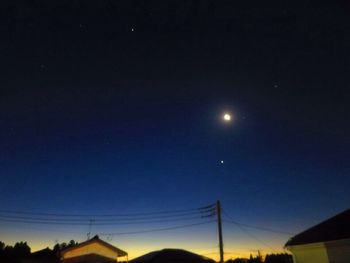 Low angle view of silhouette moon against clear sky at night